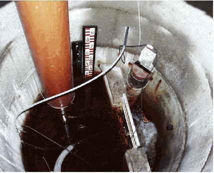 Photo 3.2. Sampling wheel for drain station in the Odderbæk catchment with two stage recorders, V-notched weir and contact switch installed. 